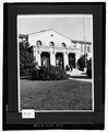 "A Bldg. 1960's". Photo no. 670. Administration Building, north part of west front, showing chimney, iron gates, and art stone decoration of the main entrance. Note also HABS CA-2729-D-31.tif